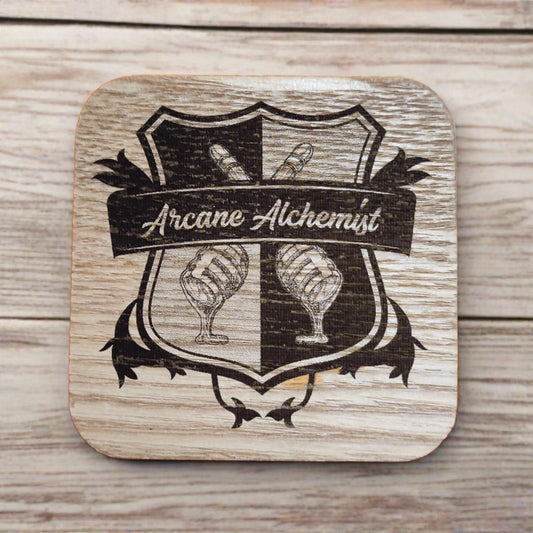 A wooden coaster with the Arcane Alchemist logo, a medieval style family crest with honey drippers as icons, lasered onto it.