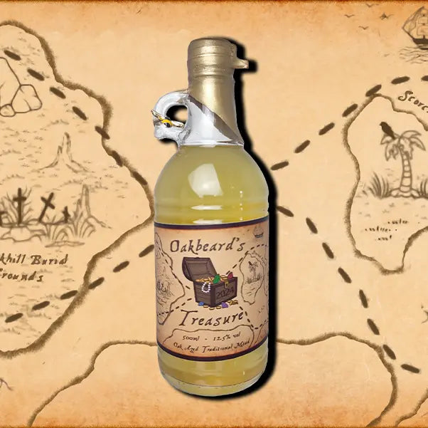 A 500ml bottle of Oakbeard's Treasure Mead. A wax dipped bottle with a label. A small bee charm hangs from the finger handle on the bottle.