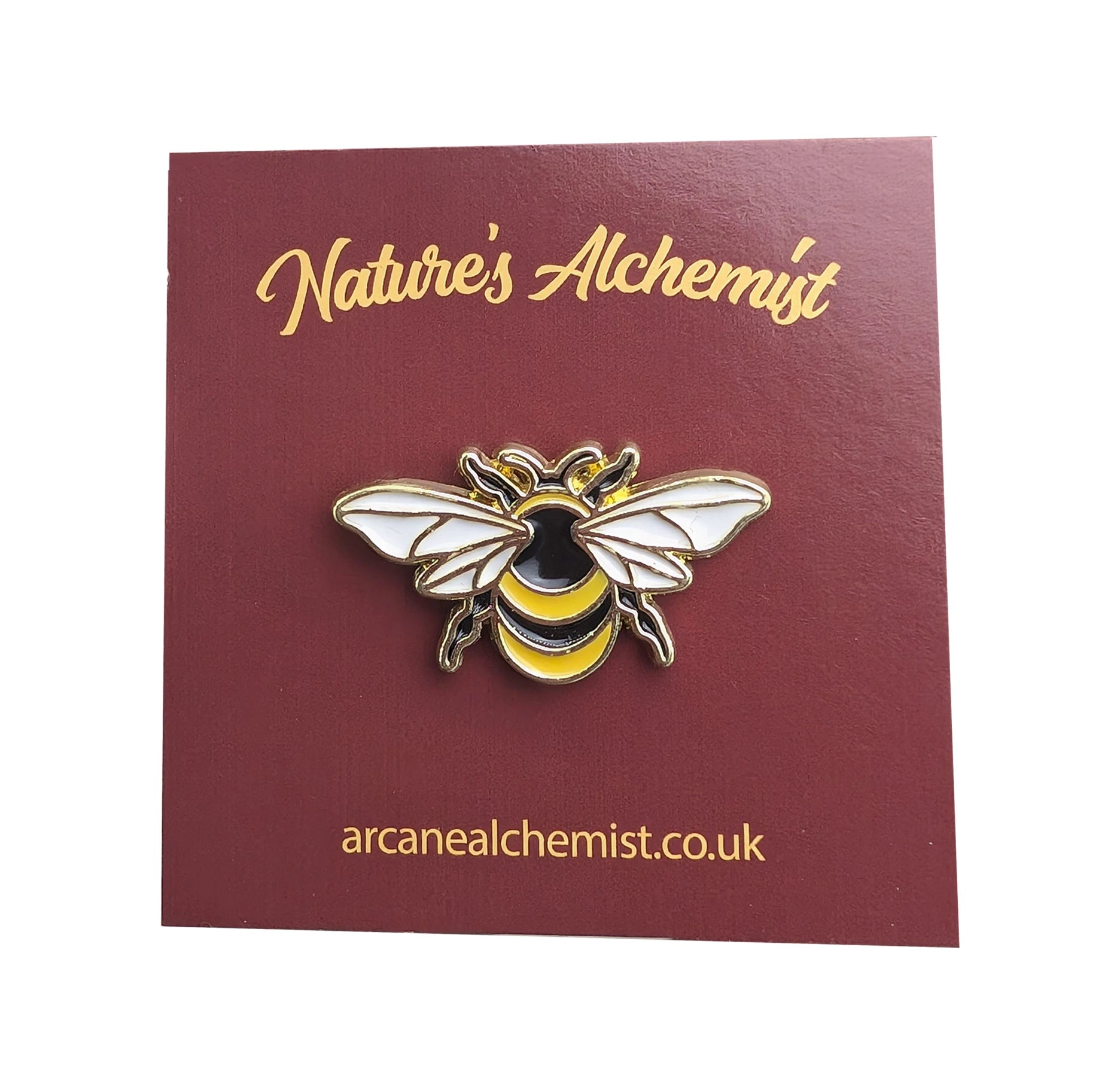 A bee pin badge on a backing card.